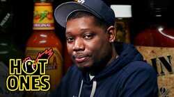Michael Che Gs Up While Eating Spicy Wings